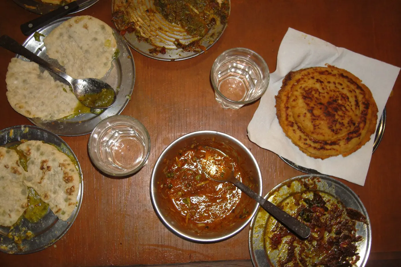 An Indian dinner table from above at the end of a heavy meal