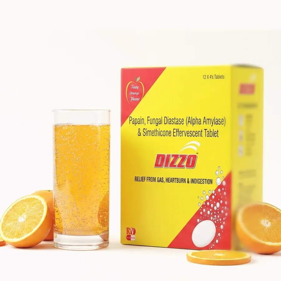 The Dizzo Tablet carton beside a glass of orange effervescent water and cut oranges