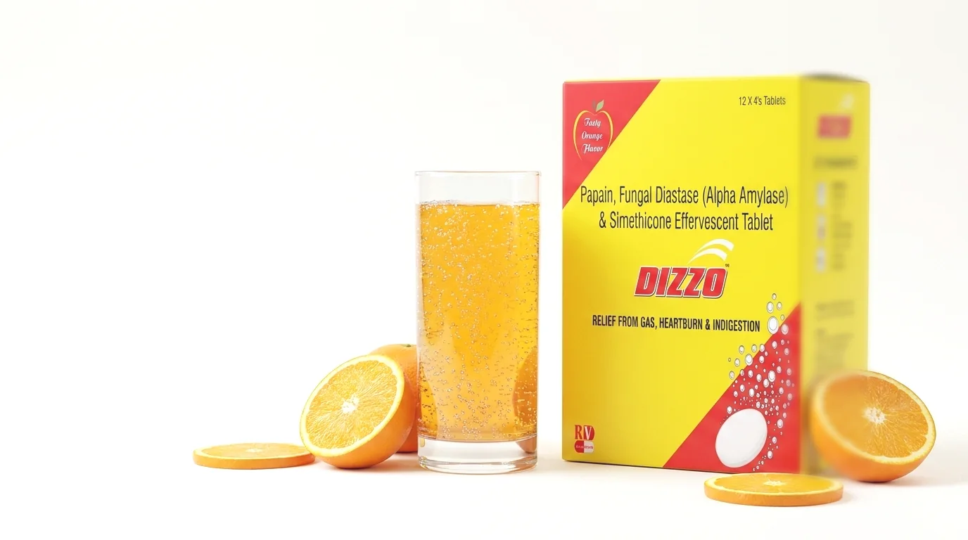The Dizzo Tablet carton beside a glass of orange effervescent water and fresh oranges